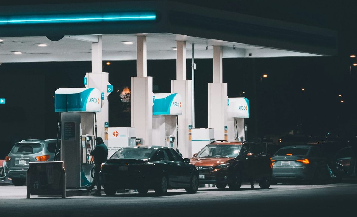 Drivers fueling cars at a gas station as technology stocks rise on strong AI demand