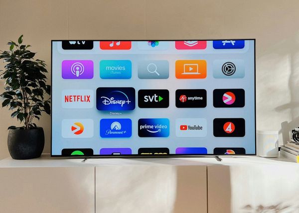 Roku streaming device and remote displayed on a television screen showing a streaming platform interface.