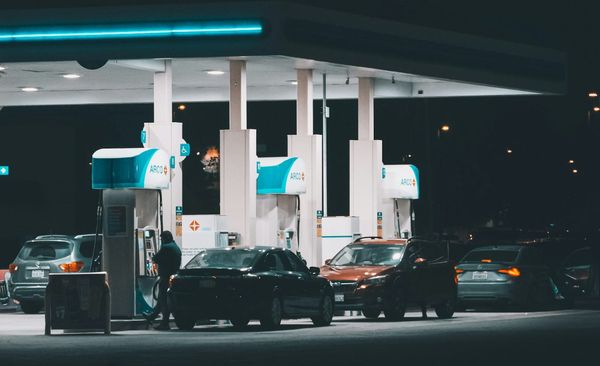 Drivers fueling cars at a gas station as technology stocks rise on strong AI demand