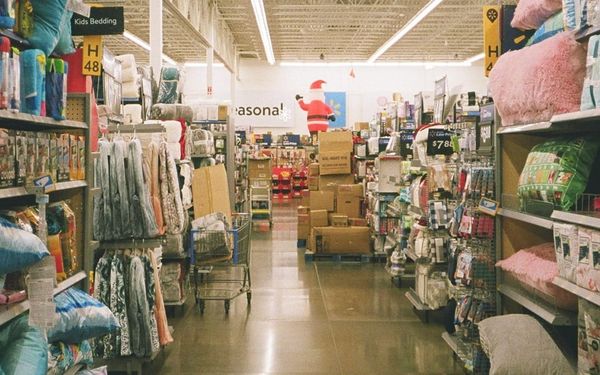 Walmart store promoting summer Rollbacks on groceries and household items.