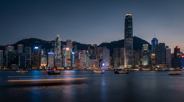 Hong Kong skyline at blue hour reflected on Victoria Harbour
