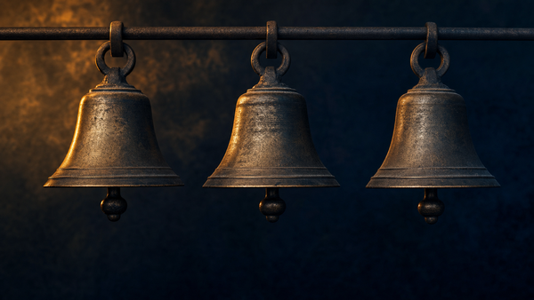 Three vintage brass bells suspended in a row against a dark navy background with amber rim lighting