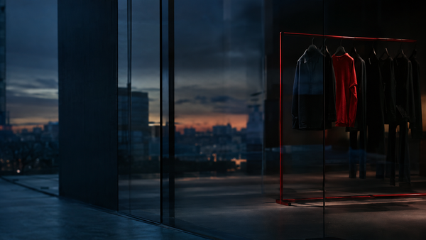 Premium athleticwear storefront at dusk with a single red garment rack