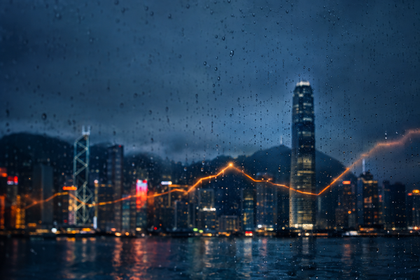 Rainy Hong Kong skyline with an amber market line, illustrating dollar funding pressure