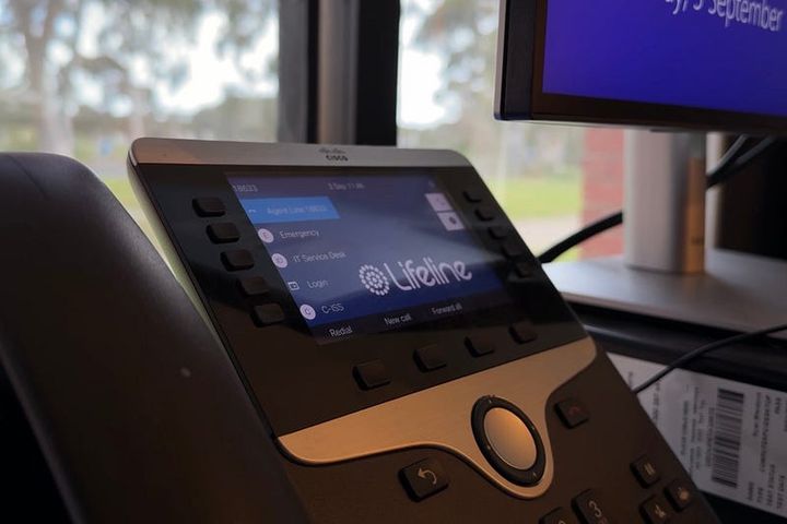 Close-up photo of a phone handset with the Lifeline logo on the screen.