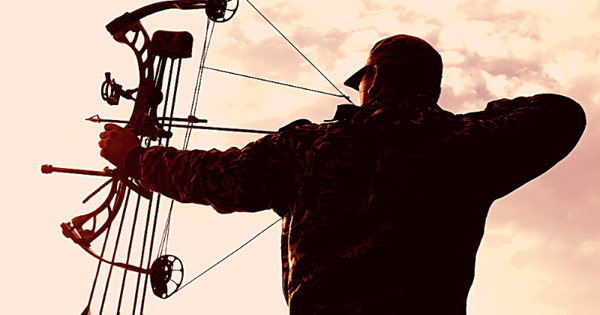 A hunter sitting quietly in a deer stand at sunrise, surrounded by autumn woods, symbolizing peace, solitude, and connection with nature.