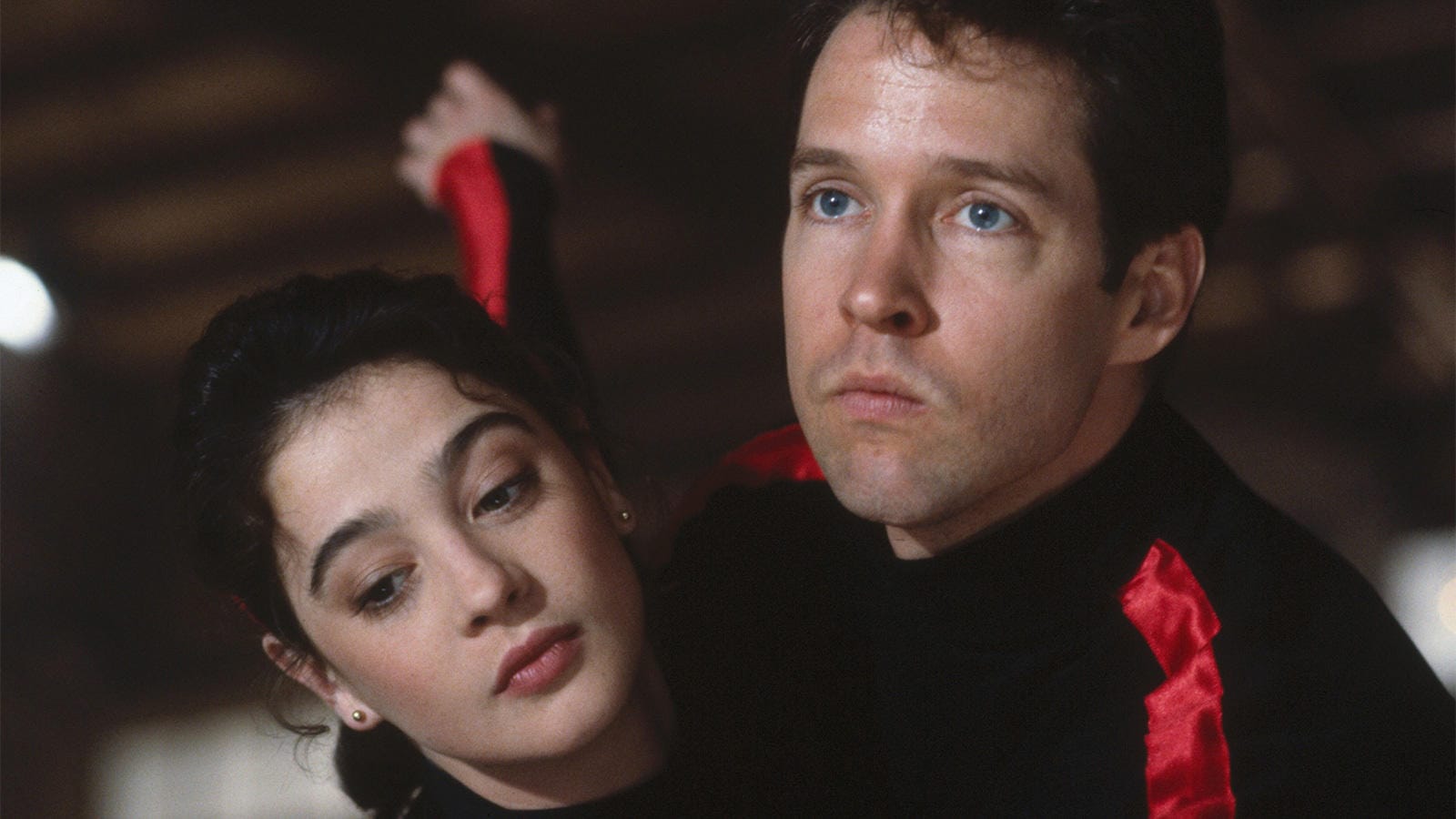 A still from the movie The Cutting Edge with the male and female leads — the woman looks gorgeous, but the man looks dopey as hell