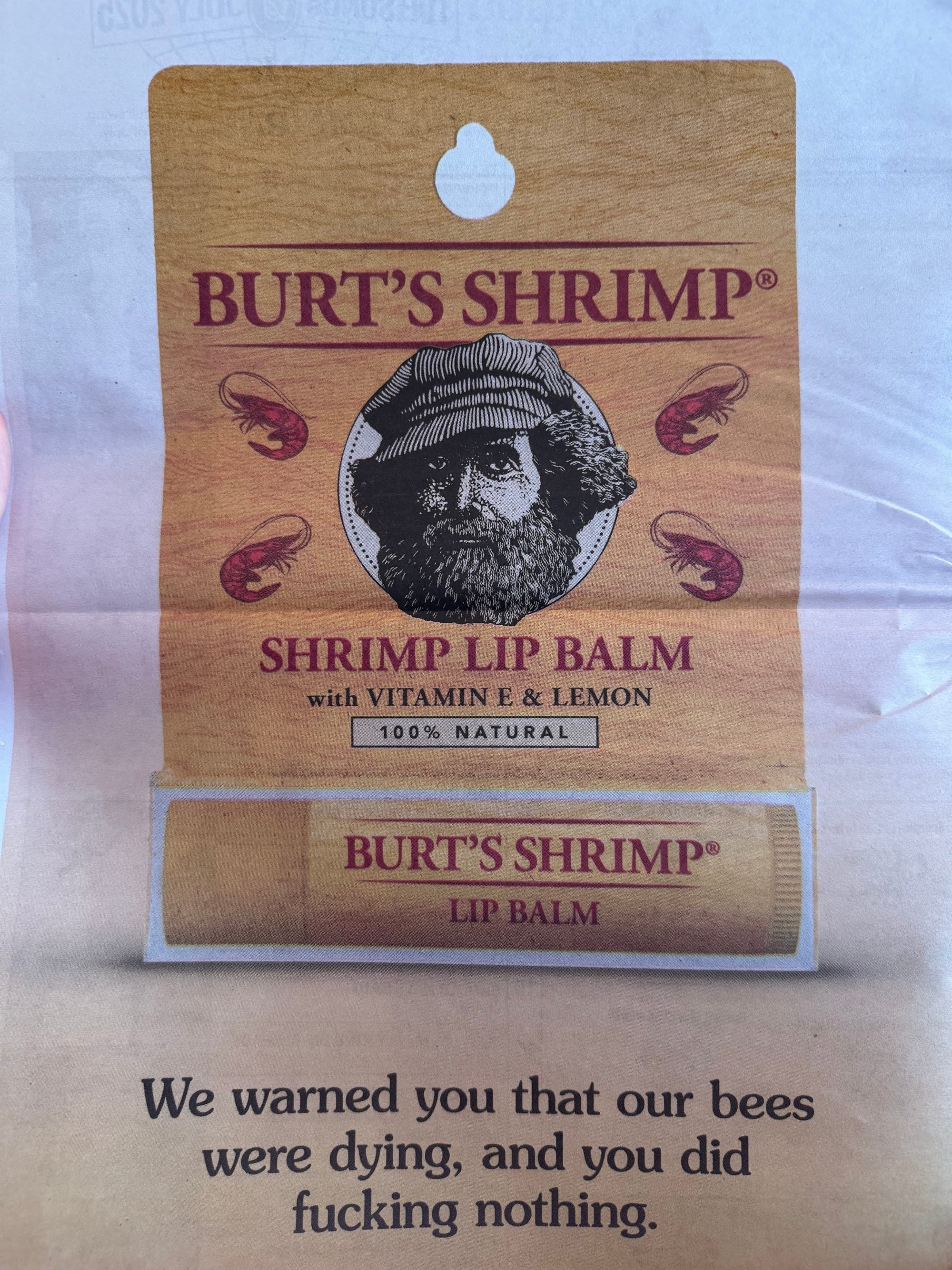 A fake ad for a lip balm from a company renamed "Burt's Shrimp" with copy that reads: "We warned you that our bees were dying, and you did fucking nothing."