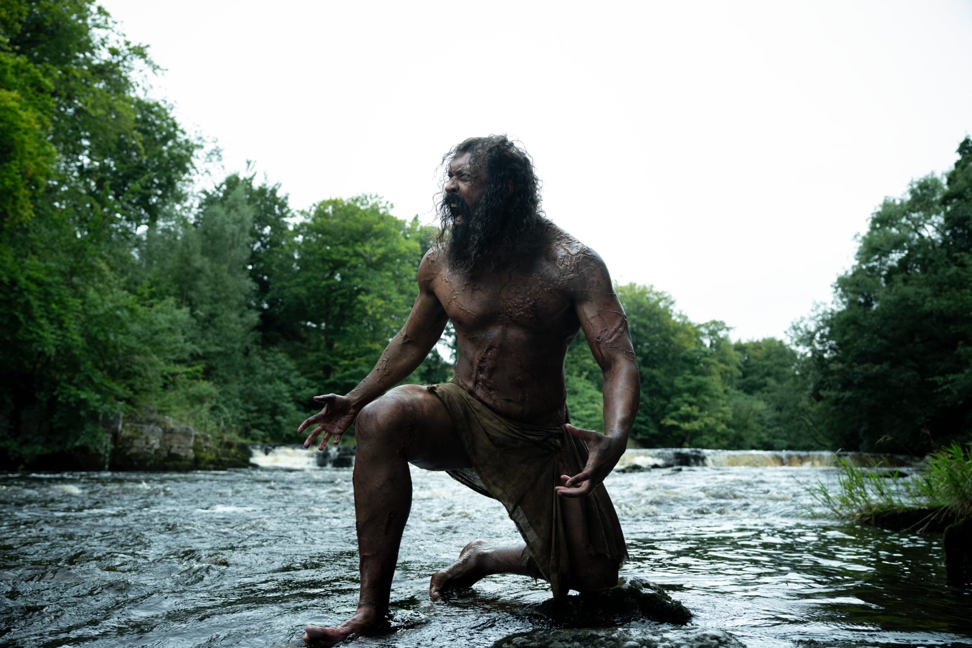 A still from The Bone Temple, showing the zombie known as Samson, who is very naked and very muscular and, sorry, hot, even though he's also, as noted, a zombie