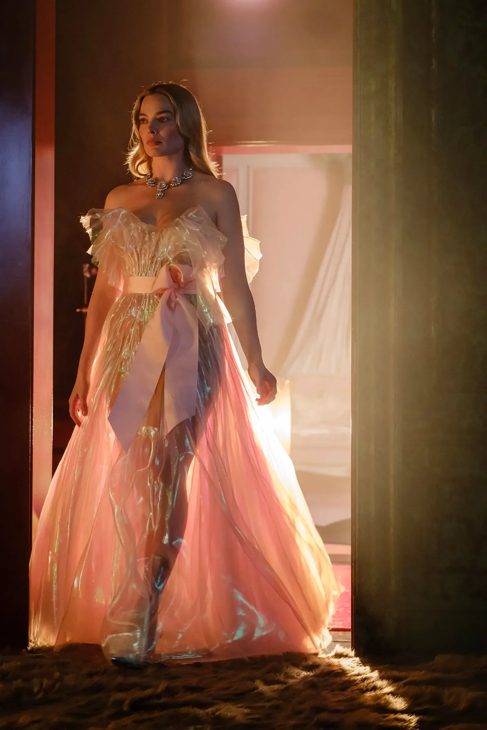 A still from Wuthering Heights, showing Margot Robbie in a CELLOPHANE PINK DRESS that drove me insane