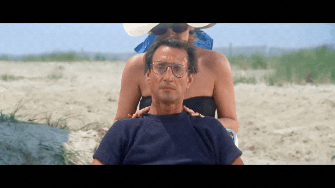 Gif from Jaws showing a dolly zoom on Roy Scheider as he sits on the beach.