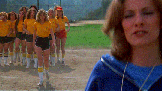Gif from Carrie, showing a girl walking forwards to where a woman is jogging on the spot.