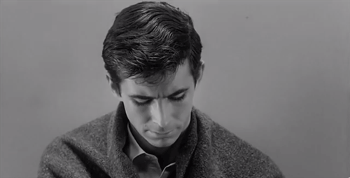Anthony Perkins in Psycho, smiling creepily and looking right at  you