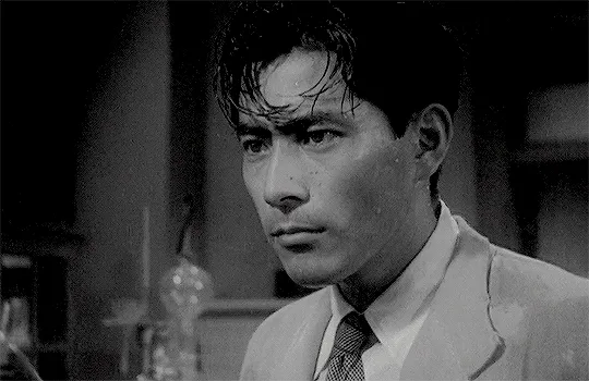 Gif of Toshiro Mifune in Stray Dog, wearing a suit and tie, simply drenched in sweat but so handsome