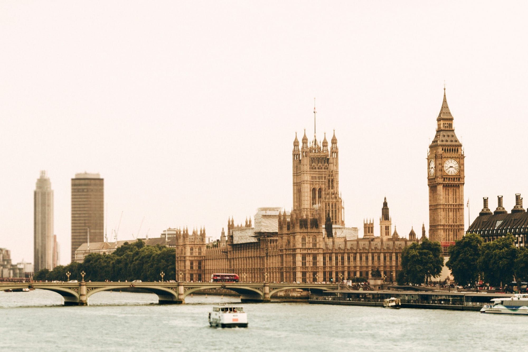 Photo of the Houses of Parliament across the Thames on an overcast day