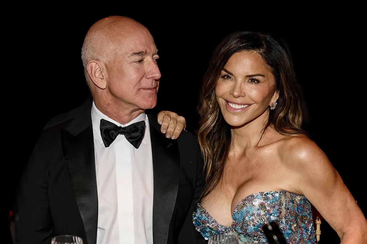 Lauren Sánchez leans on Jeff Bezos' shoulder while he looks at her