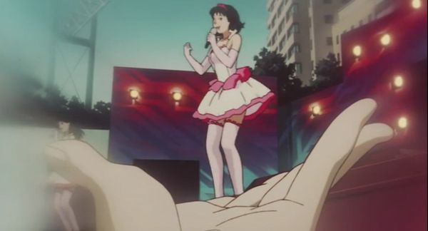 Still from Perfect Blue, from POV shot of a fan in the crowd holding his hand to make it look like Mima is standing in it