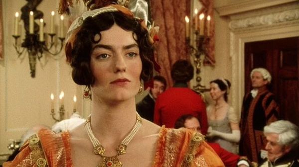 Anna Chancellor looking haughty in orange at a party, screenshot from Pride & Prejudice (1995