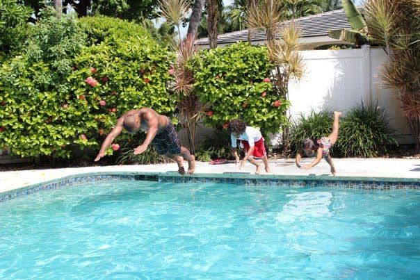 A family diving into a pool