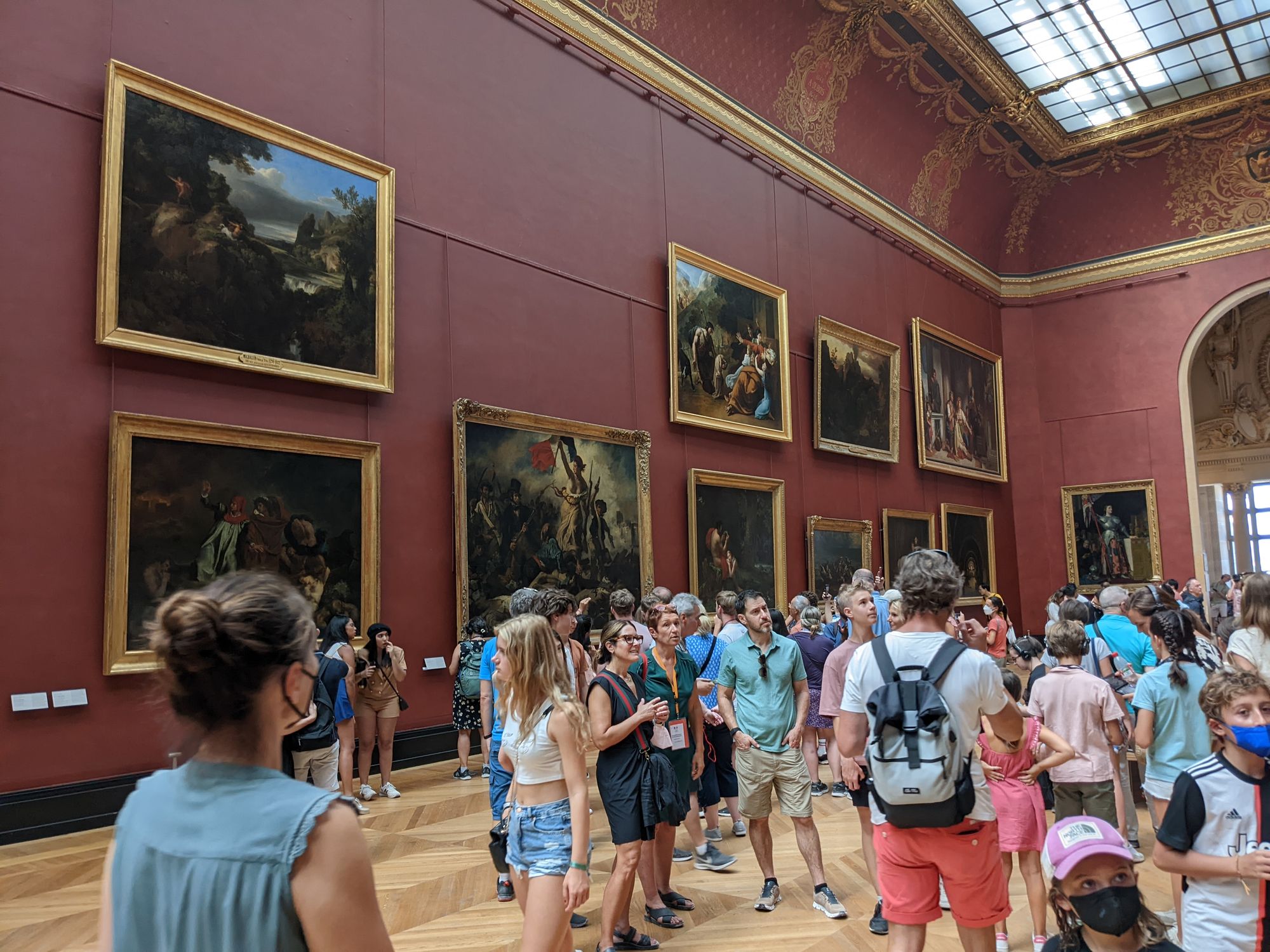 PAintings in an exhibition room at the Louvre Museum in Paris