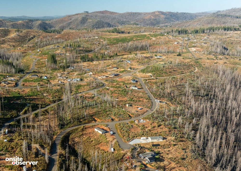 An aerial view of Grizzly Flats in El Dorado County shows fire-scarred hillsides and homes five years after the 2021 Caldor Fire.