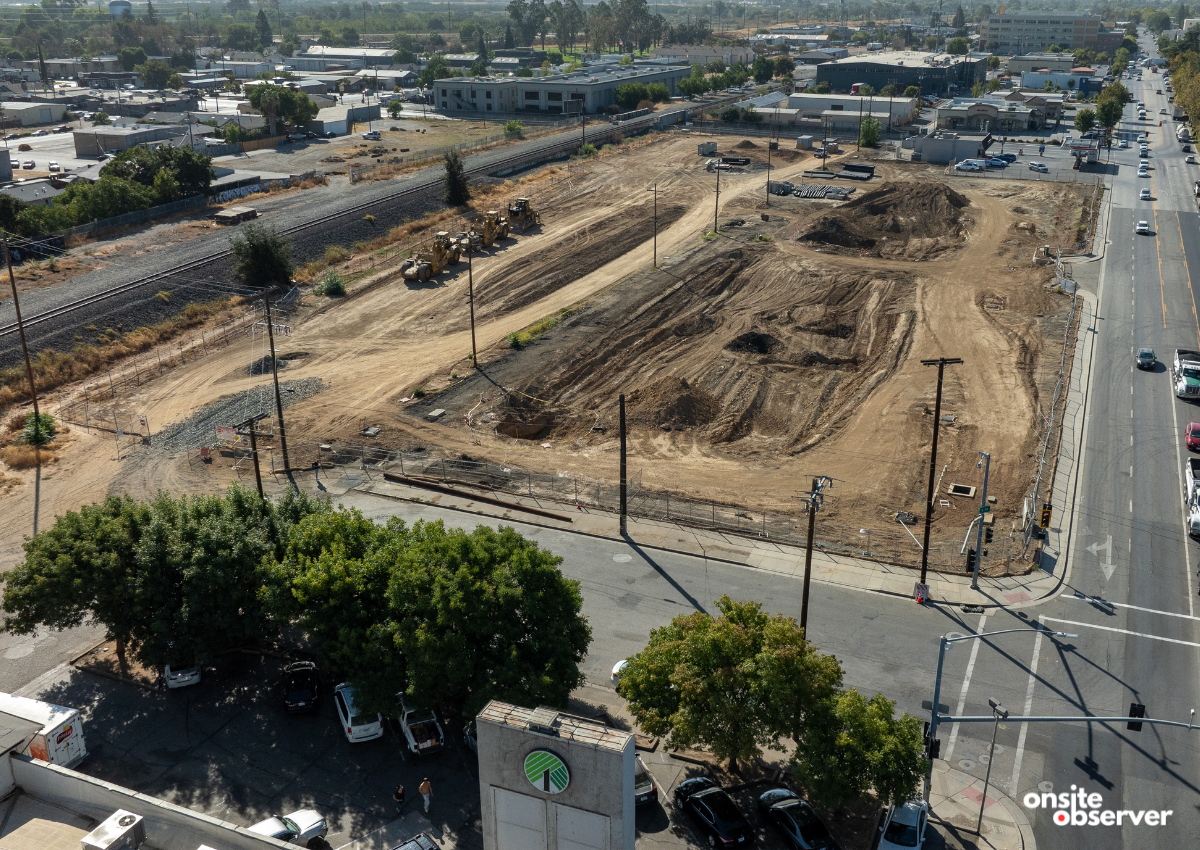 Aerial view shows grading and utility work underway at Marysville’s B Street project site, where a Hyatt Studios hotel, Grocery Outlet, and Starbucks are planned across from Ellis Lake.