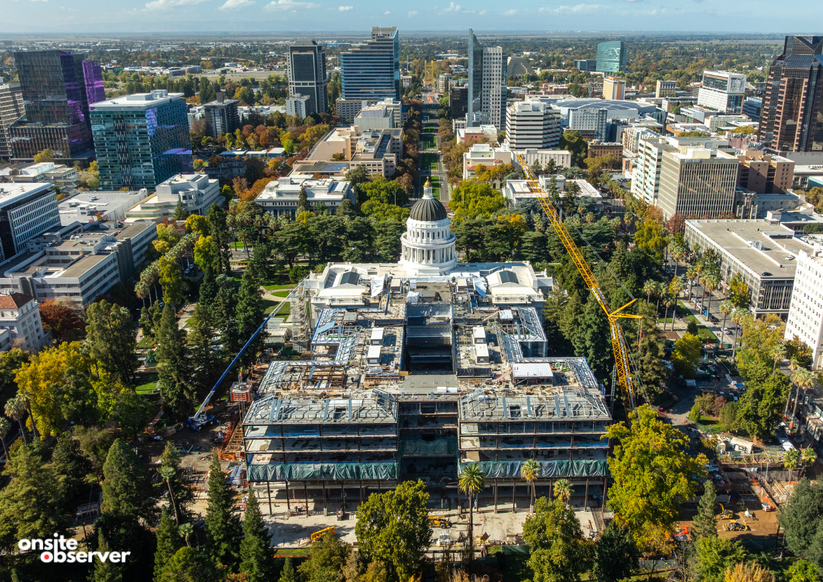 Aerial view shows the ongoing construction of California’s new Capitol Annex building rising behind the historic State Capitol dome in downtown Sacramento.