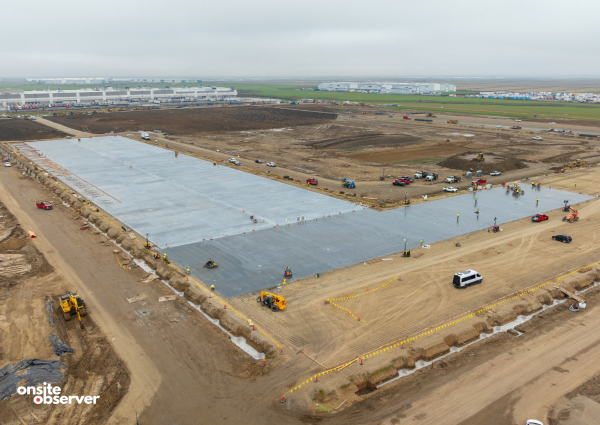 An aerial view shows a newly poured concrete foundation and ongoing site work at Costco’s distribution depot under construction at Metro Air Park. Image courtesy of Onsite Observer. 