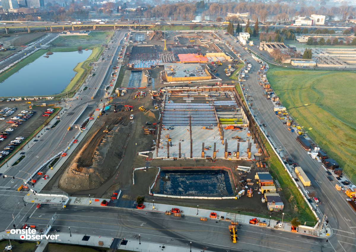 Aerial view shows Kaiser Permanente’s Railyards Medical Center taking shape, with concrete slabs in place and vertical construction now underway in downtown Sacramento. 