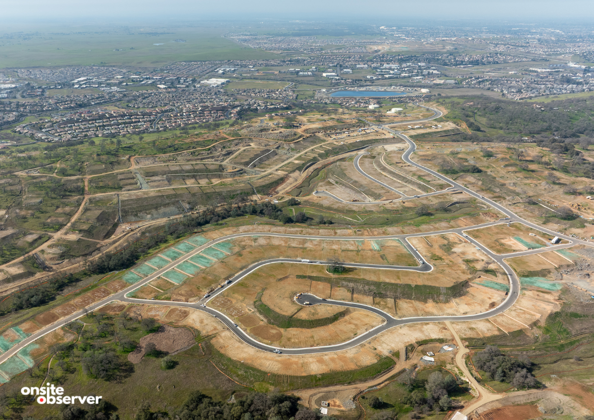 Aerial view shows newly paved roads and graded lots as infrastructure work continues at East Ridge Village in El Dorado Hills. Image: Onsite Observer.