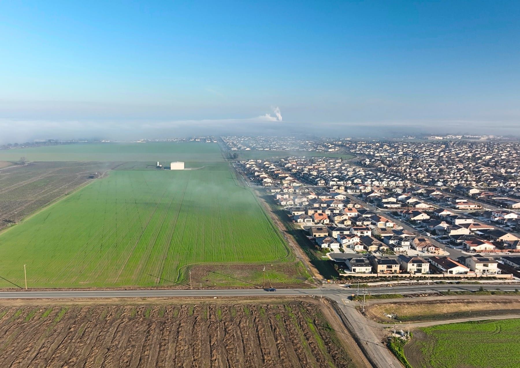 An aerial view shows farmland within the Woodland Research and Technology Park area next to the Spring Lake neighborhood