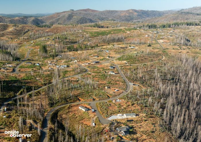 An aerial view of Grizzly Flats in El Dorado County shows fire-scarred hillsides and homes five years after the 2021 Caldor Fire.