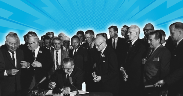 President Lyndon B. Johnson signs the Voting Rights Act of 1965 surrounded by civil rights leaders and lawmakers