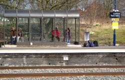 Passengers in a shelter at Lichfield Trent Valley railway station
