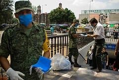 Soldiers hand out masks on the streets of Mexico following the swine flu outbreak. Pic: Eneas De Troya