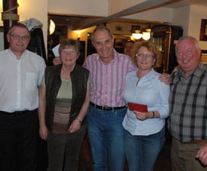 The winning team receive their prize from Roger Manning (centre)