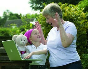 Rhiannon Stone shows her nan Mary Price the new website with the help of her teddy bear Pinky