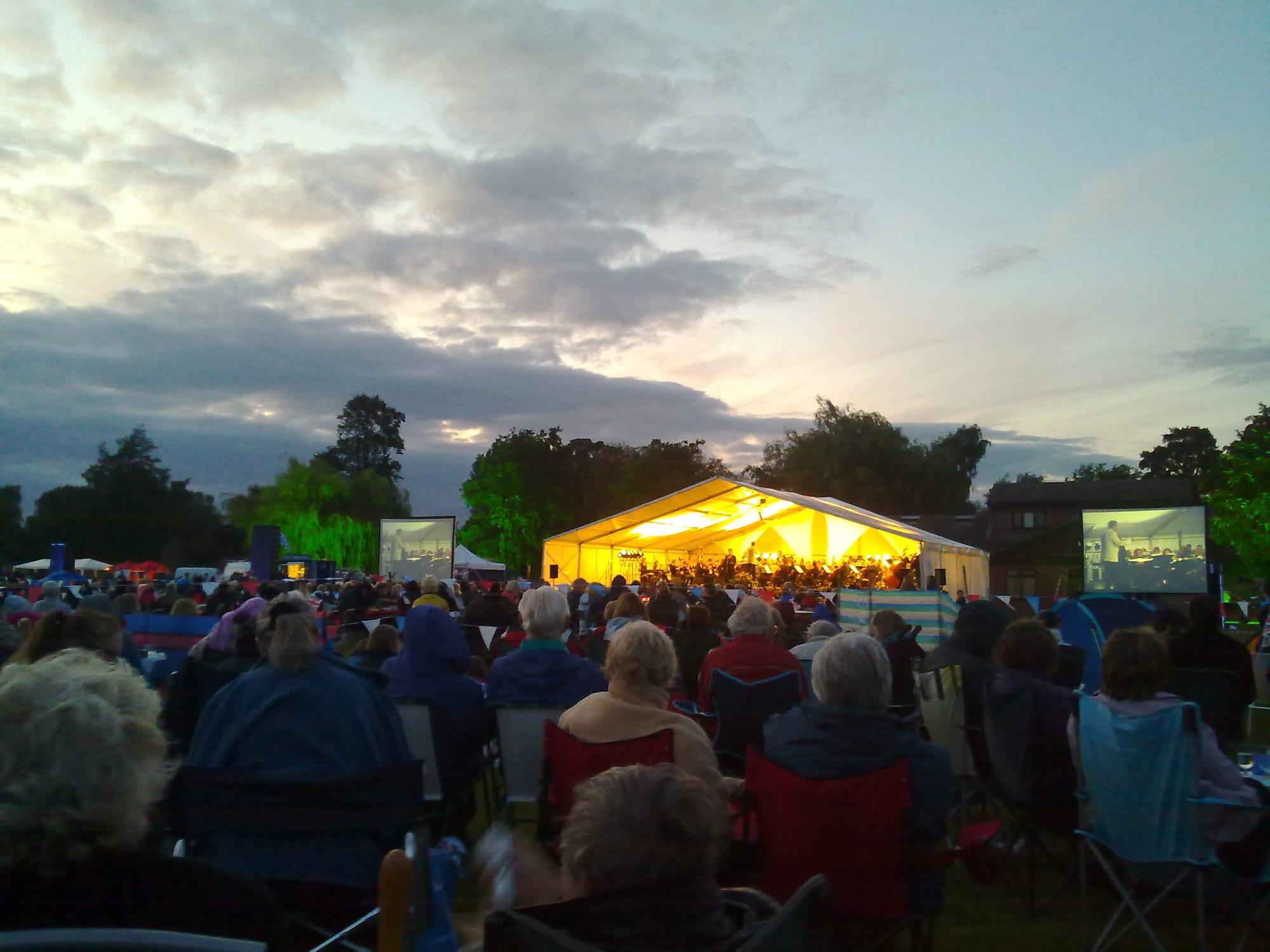 The crowd look on under clearing skies