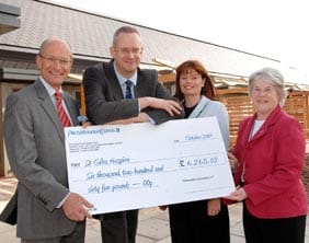 Peter Holliday (left) and Laura Pennycuick (right) receive the donation from PricewaterhouseCoopers’ Midlands Forensic Services Managers Andrew Meadows and Ansie Delport