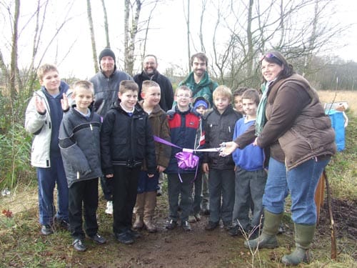 Eleanor Pickard (from Natural England who funded the boardwalk and info board) cutting the ribbon. The chaps at the back are (left to right): Ian Karnes (Deputy Head of Chasetown Community School), Dave Knowles (The Forest of Mercia) and Chris Walsh (Biodiversity Officer for Lichfield District Council)