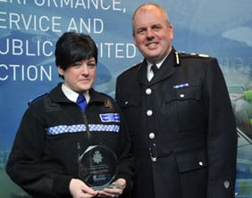 PCSO Margaret Griffiths receives her award from Chief Constable Mike Cunningham