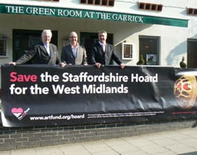 hoard Cllr David Smith, Johan Popp and Steve George with one of the new banners
