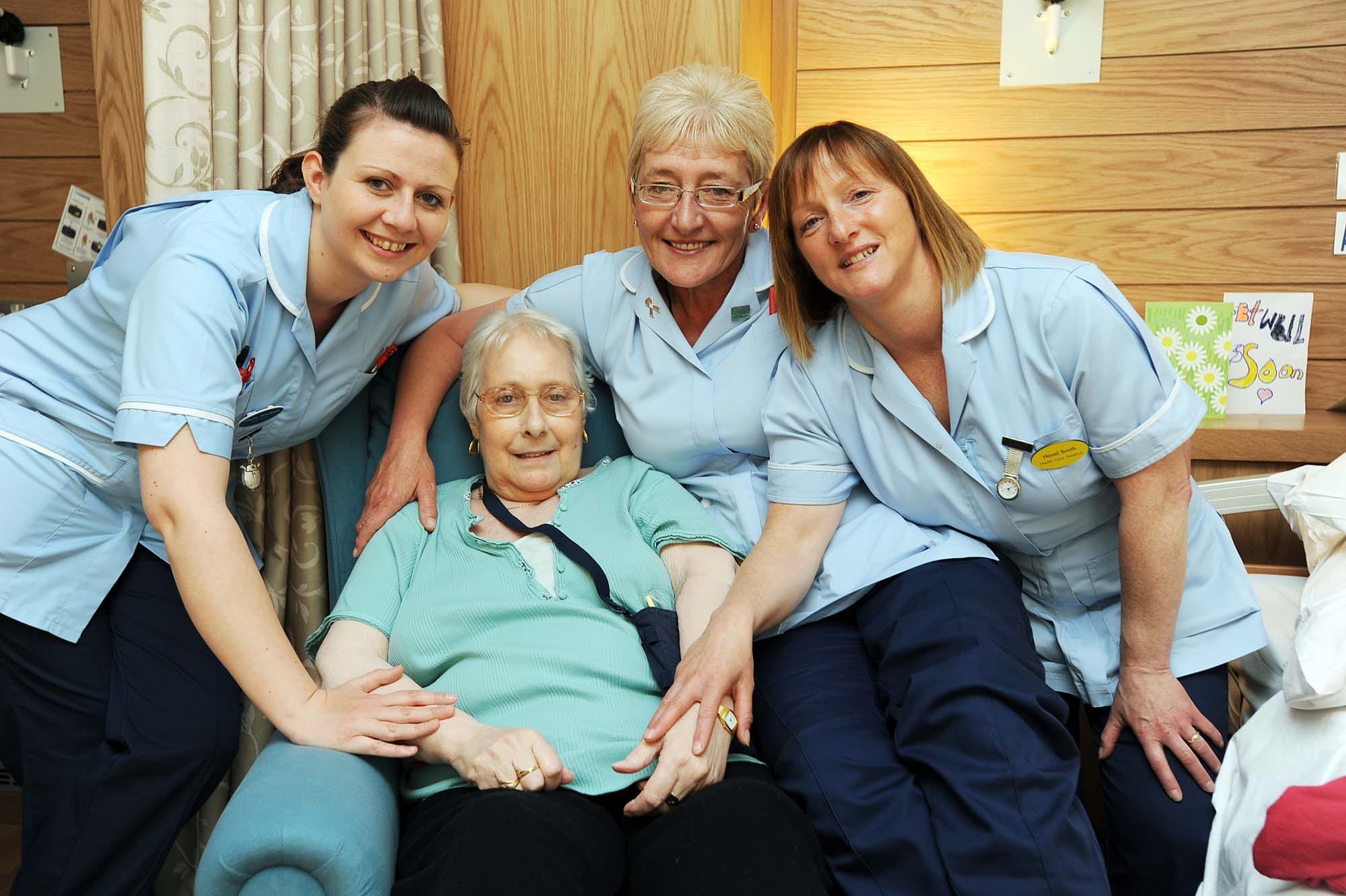 Picture of staff with a residents at St Giles Hospice Every penny from St Giles Hospice Lottery goes towards providing care for people with cancer and other serious illnesses