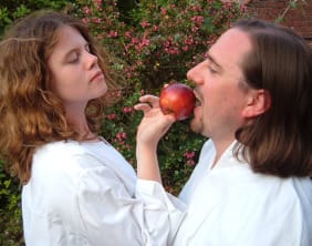 Alice Dale, as Eve, tempts Adam (with Robert Webb standing in for the actor) with an apple in A Bite of the Mysteries.