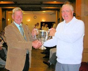 bowling Cllr Christopher Spruce hands the trophy to Museum Bowling Club chairman Roland Cope