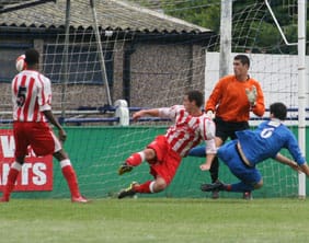 Chasetown's Chris Horton slides in to make it 3-2 against Romulus. Pic: Dave Birt