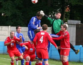 Chasetown FC goalkeeper Ryan Price punches clear against Kidsgrove Athletic