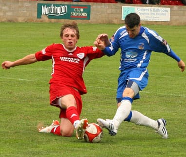 Chasetown's Dean Perrow has his shot blocked. Pic: Dave Birt