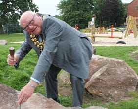 Cllr Barry Diggle carves the stone at Shortbutts Park