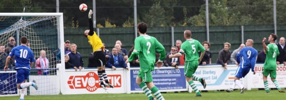 Gary Hay lobs the Burscough keeper to make it 3-0 to Chasetown. Pic: Dave Birt